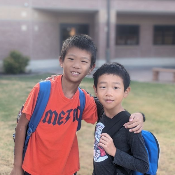 two students walking and smiling.
